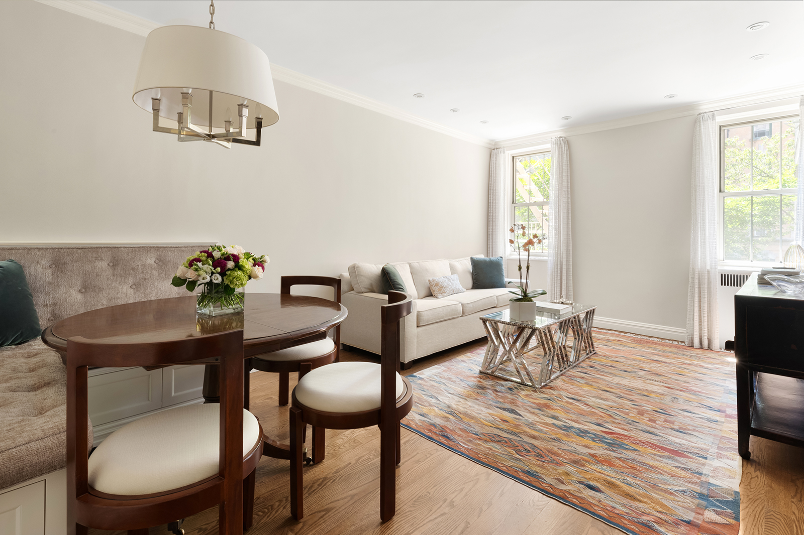 75 Bank Street, Unit 2H Manhattan, NY 10014 - Photo 1 of 18 a living room with furniture a rug and a window