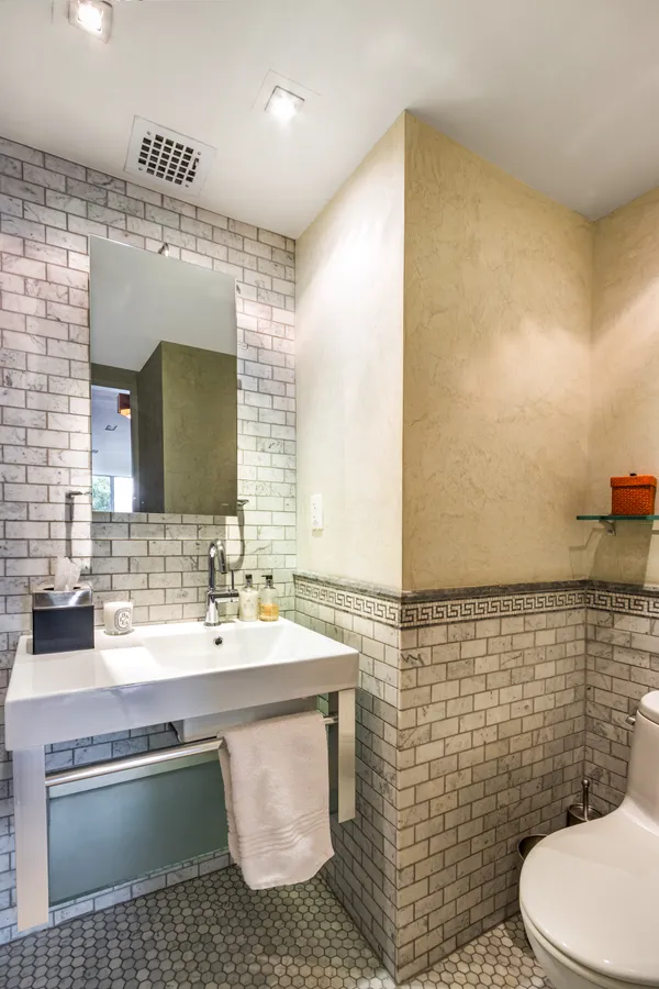 a bathroom with a sink toilet and mirror
