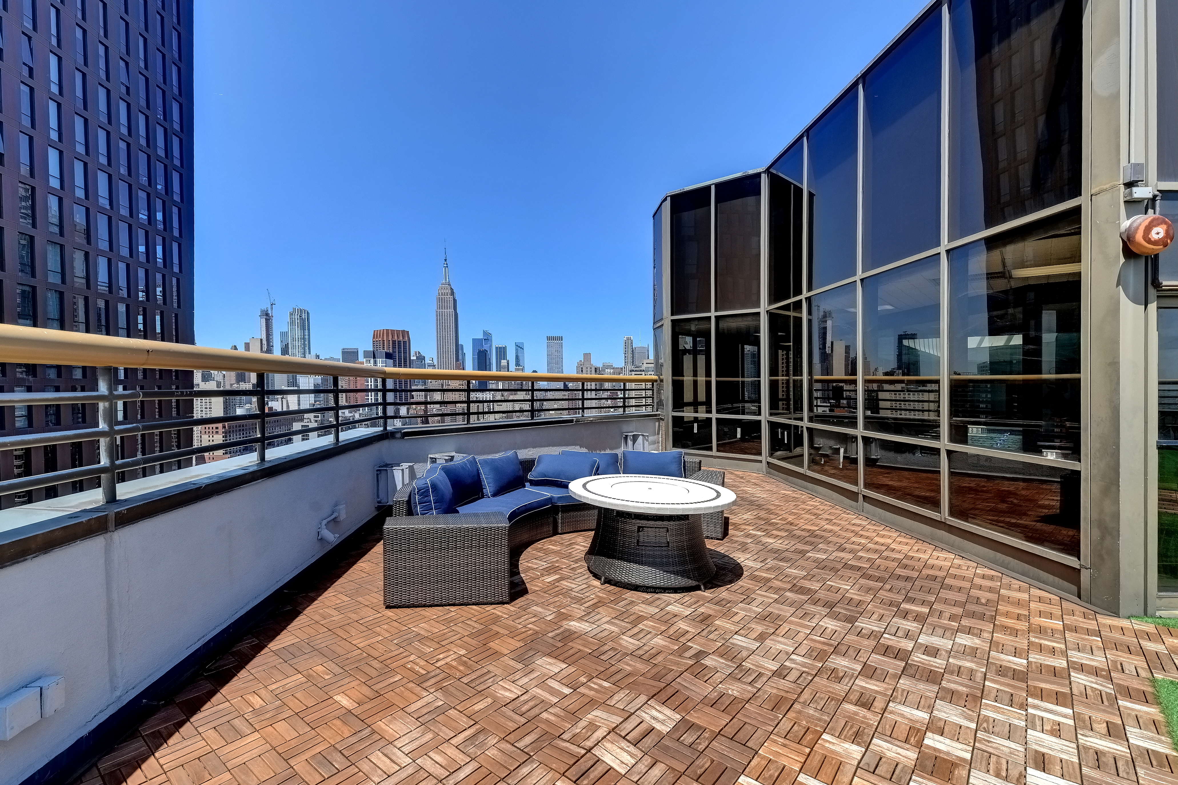 630 1st Avenue, Unit 17N Manhattan, NY 10016 - Photo 9 of 10 a view of balcony with two chairs and a potted plant