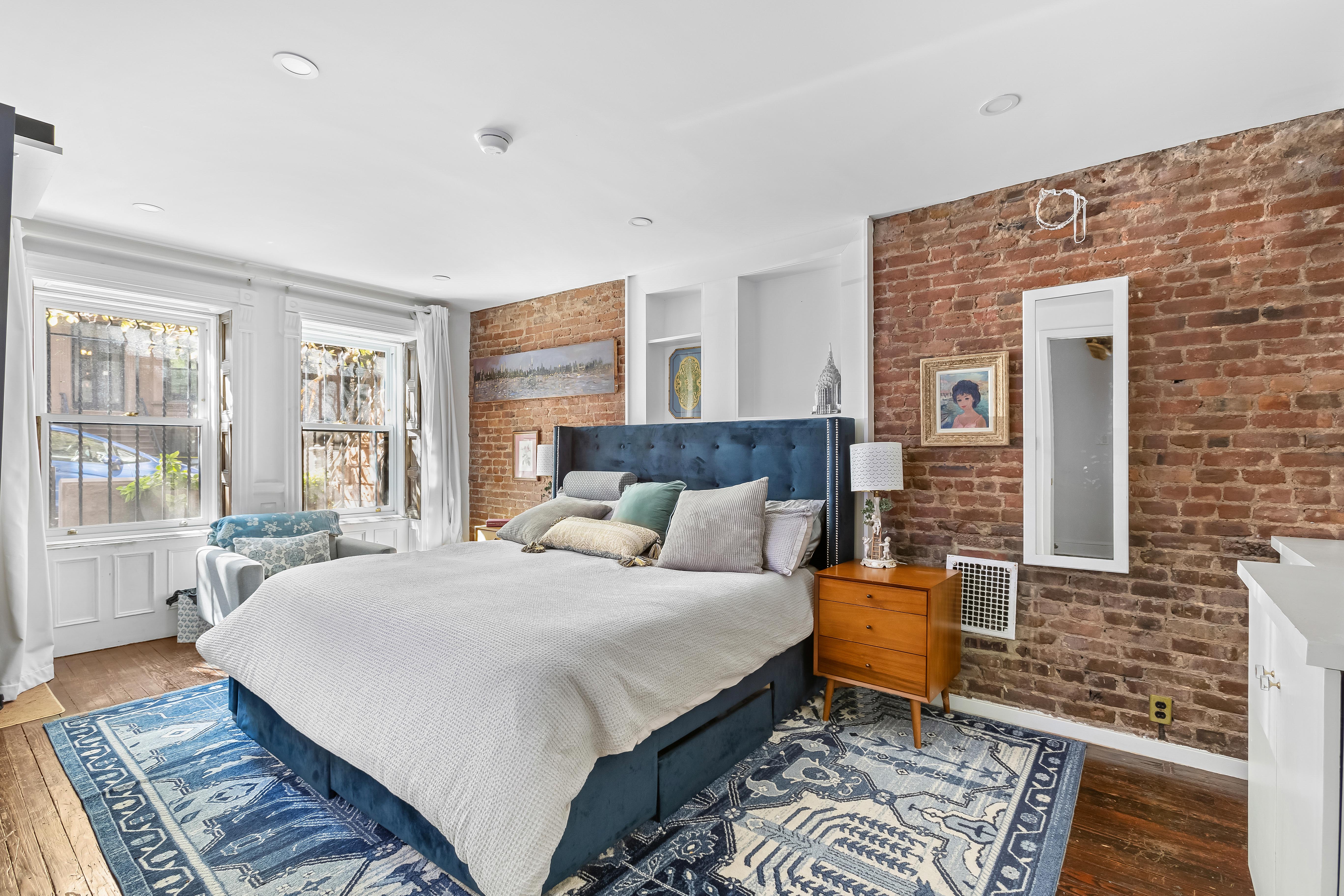 227 Garfield Place, Unit Garden Duplex Brooklyn, NY 11215 - Photo 8 of 15 a large bedroom with a bed and wooden floor