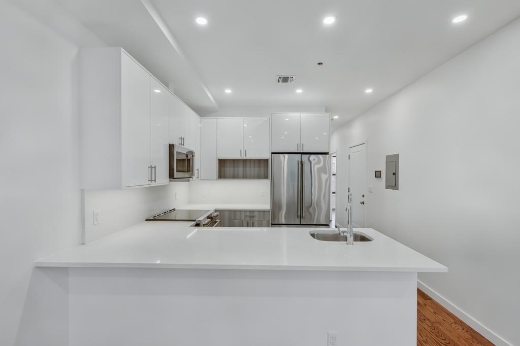 109 President Street, Unit 4 Brooklyn, NY 11231 - Photo 4 of 22 a bathroom with a sink a mirror and shower