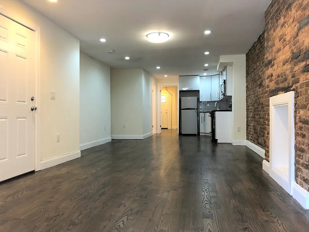 313 Van Buren Street Brooklyn, NY 11221 - Photo 8 of 20 a view of a kitchen with a sink and a refrigerator