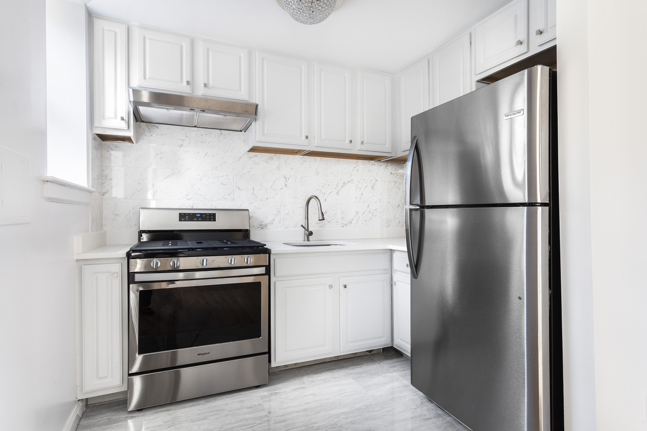 660 St Nicholas Avenue, Unit 63 Manhattan, NY 10030 - Photo 8 of 14 a white refrigerator freezer and a stove sitting inside of a kitchen