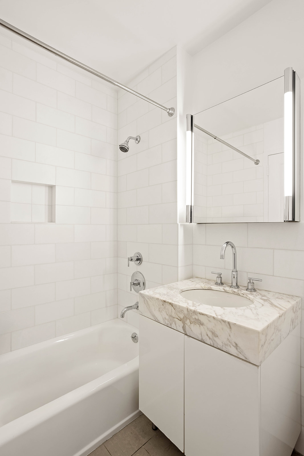 300 East 64th Street, Unit 26B Manhattan, NY 10065 - Photo 13 of 26 a bathroom with a granite countertop sink and a bathtub
