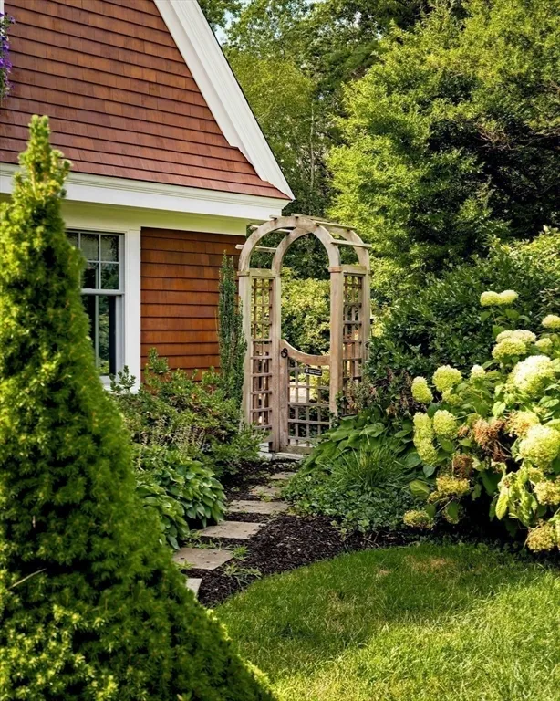 a front view of a house with a yard and trees