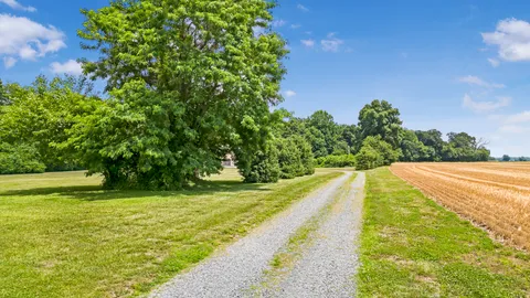 a view of a white house with a yard