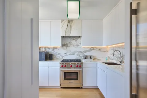 a kitchen with stainless steel appliances granite countertop a stove and a refrigerator