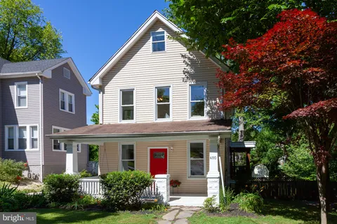 a front view of a house with plants and garden