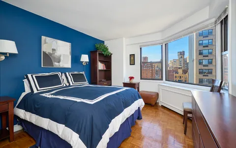 a bedroom with a large bed and a large window