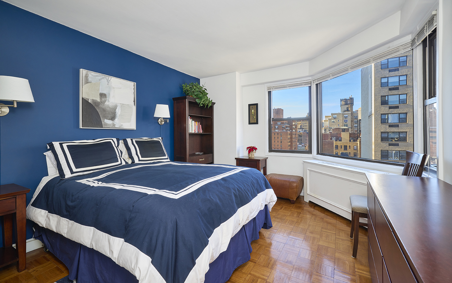201 East 83rd Street, Unit 14E Manhattan, NY 10028 - Photo 5 of 8 a bedroom with a large bed and a large window