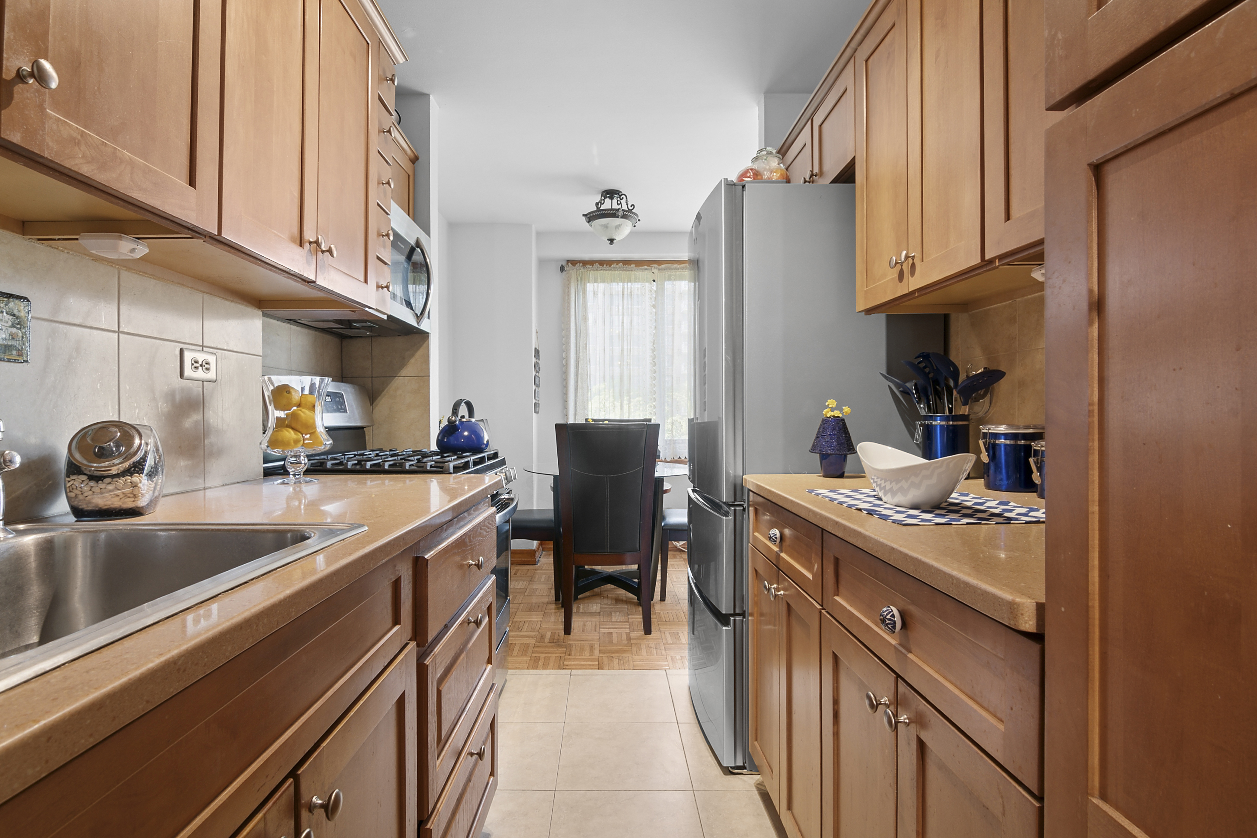 195 Willoughby Avenue, Unit 518 Brooklyn, NY 11205 - Photo 3 of 7 a kitchen with stainless steel appliances granite countertop a sink stove and refrigerator