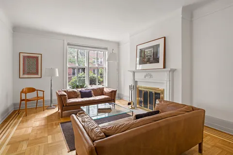 a living room with furniture fireplace and window
