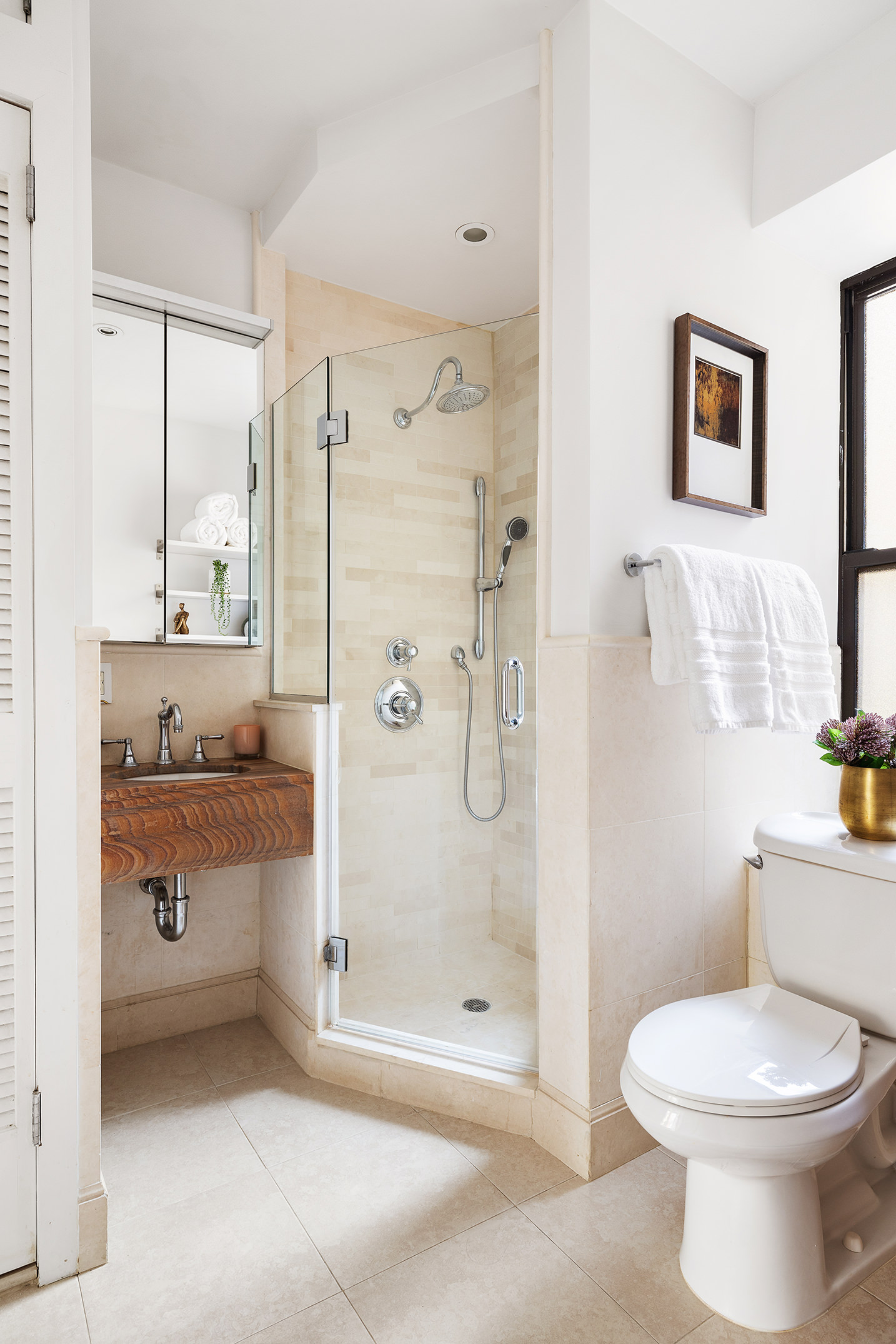 203 West 81st Street, Unit 3A Manhattan, NY 10024 - Photo 11 of 12 a bathroom with a granite countertop sink a toilet and shower