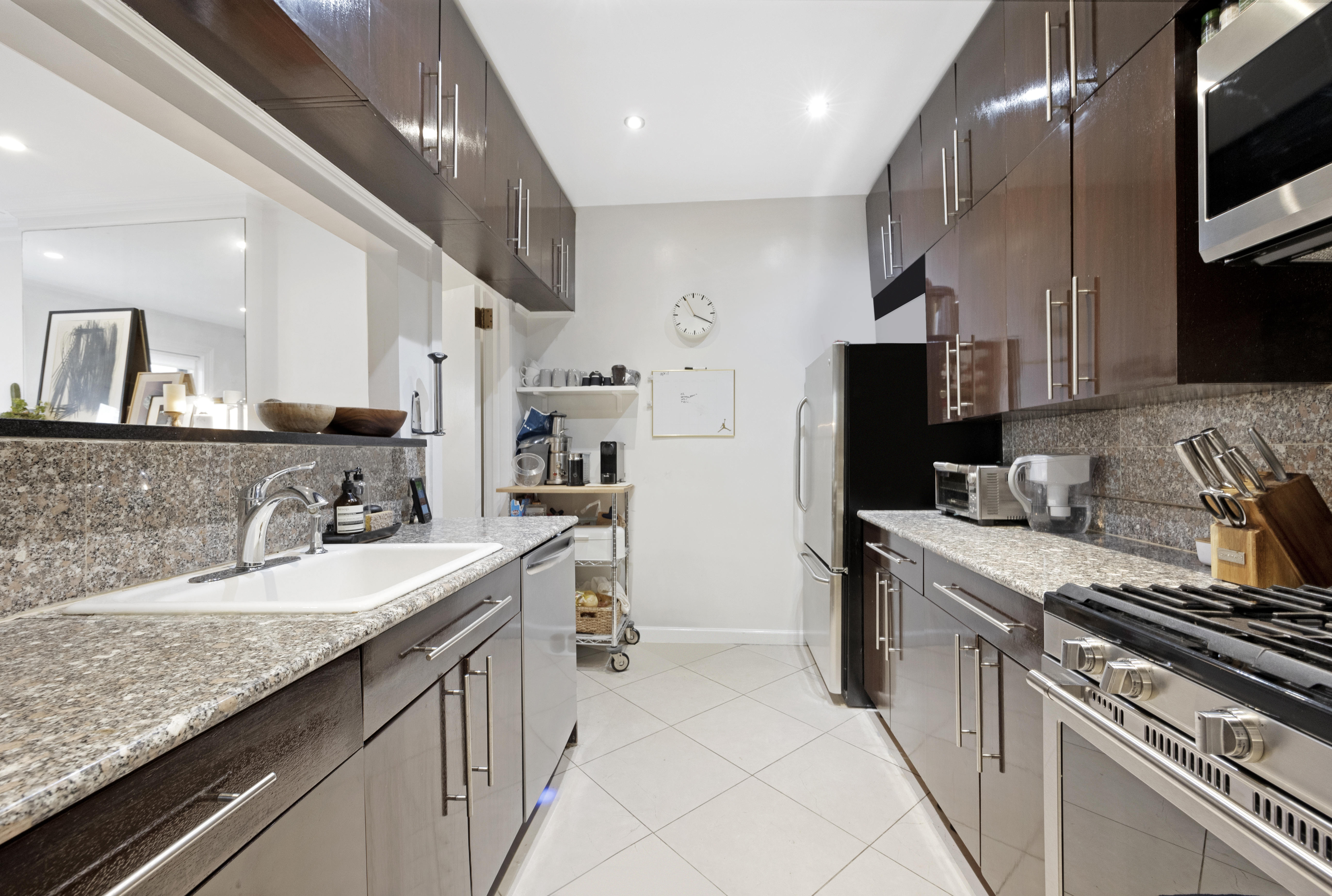 152 East 74th Street, Unit 2 Manhattan, NY 10021 - Photo 5 of 16 a kitchen with granite countertop a sink stove and refrigerator