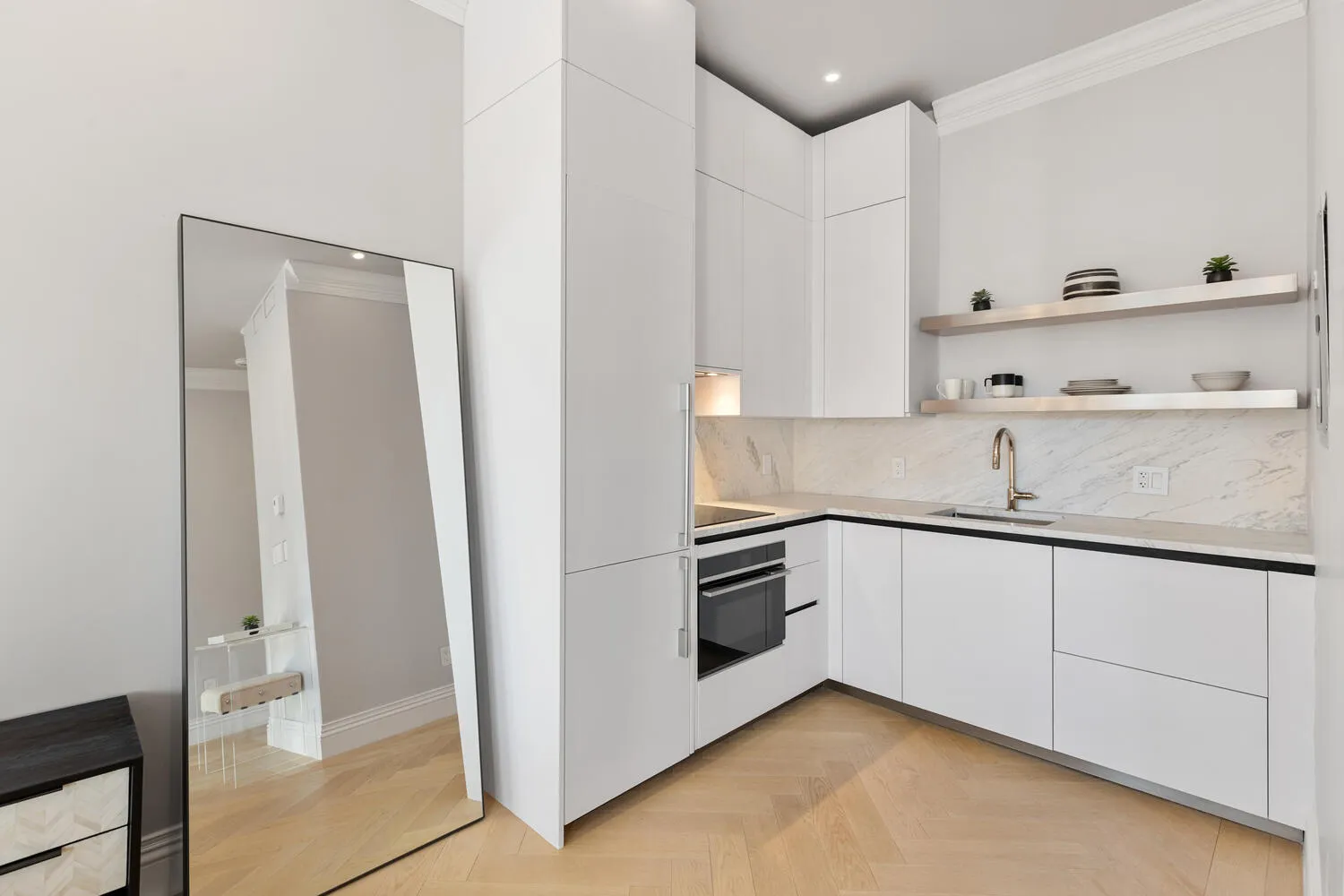 a kitchen with granite countertop white cabinets and white appliances
