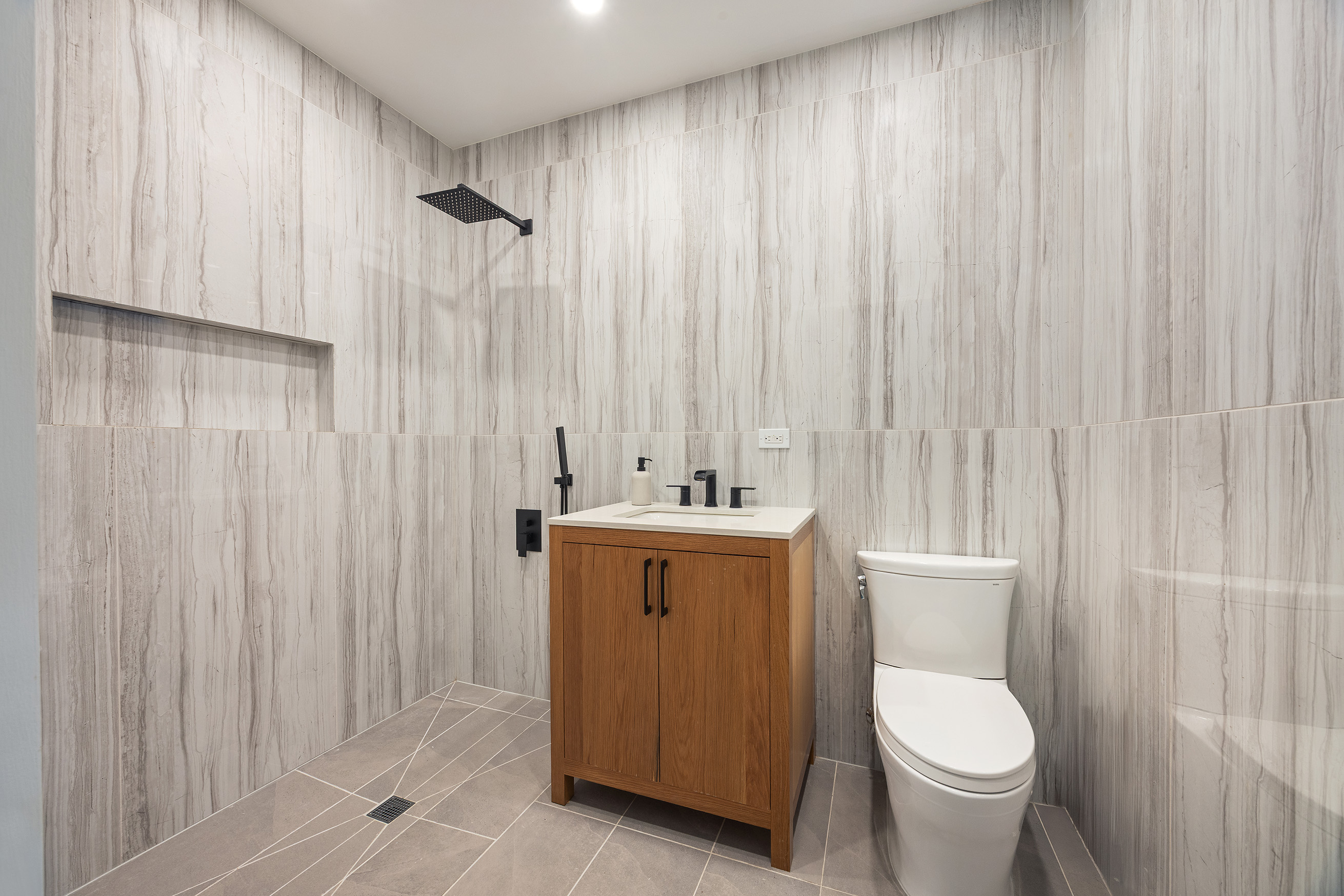 1423 Park Place Brooklyn, NY 11213 - Photo 10 of 17 a bathroom with a sink a toilet and shower curtain