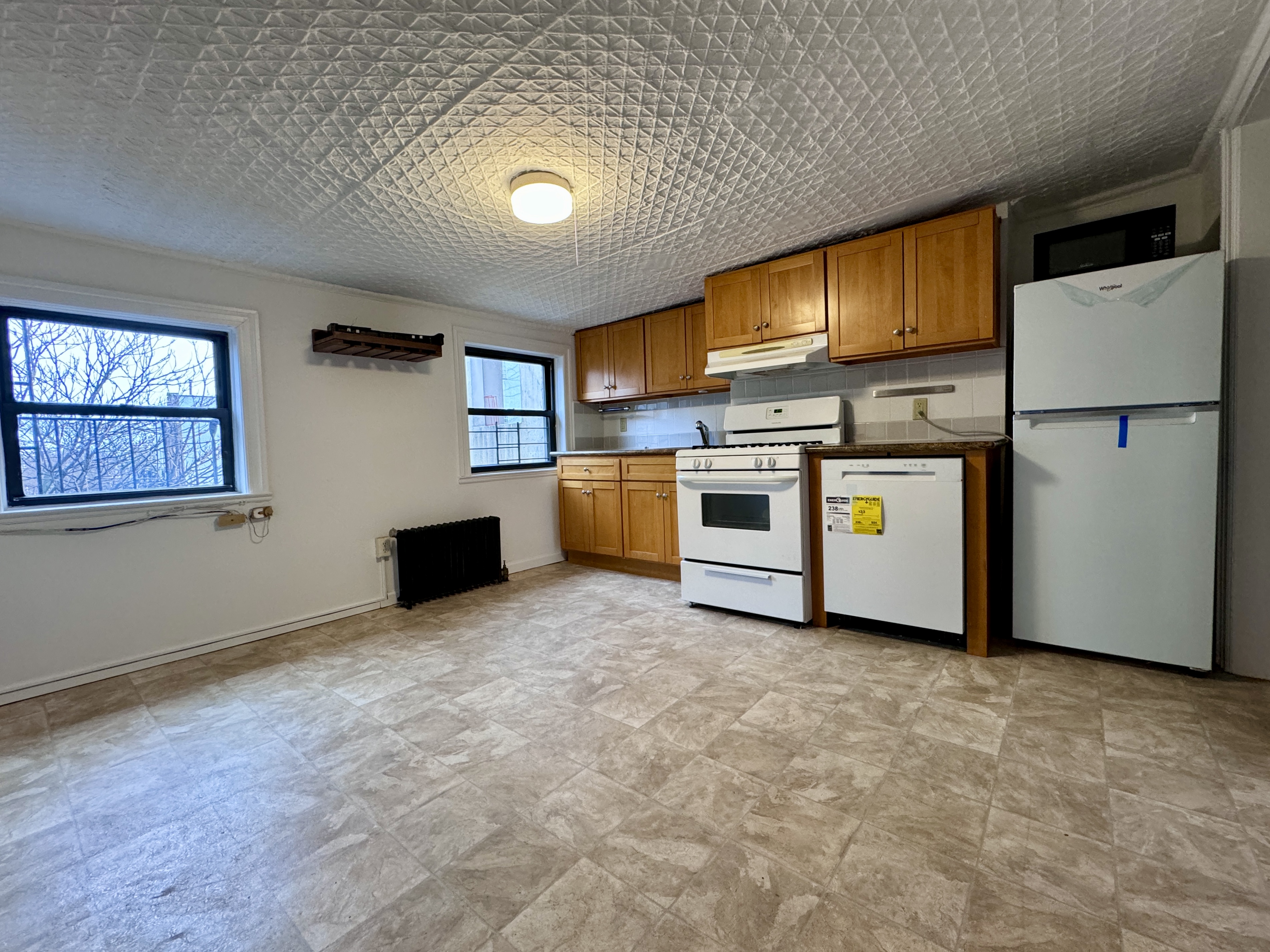 195 Court Street, Unit 4 Brooklyn, NY 11201 - Photo 4 of 11 a kitchen with stainless steel appliances granite countertop a refrigerator a stove top oven a sink and dishwasher
