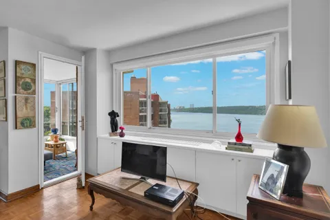 a living room with a large window and a table