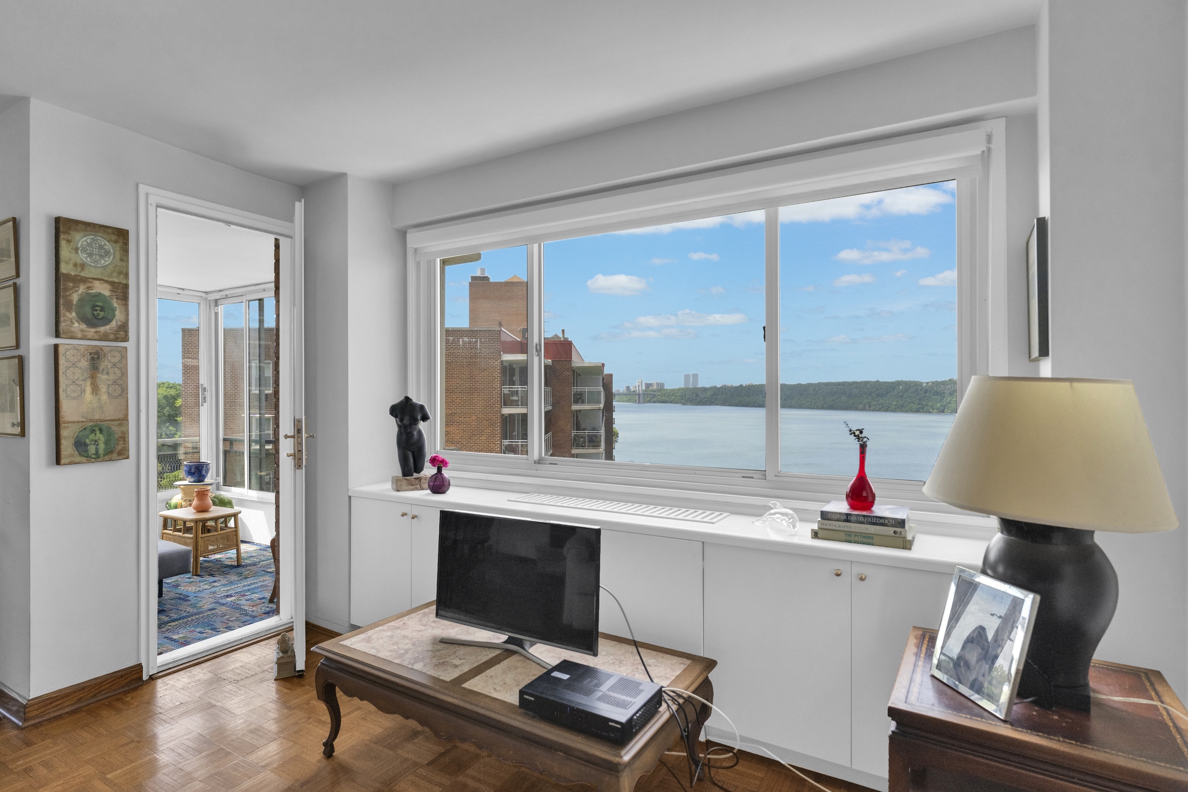 2621 Palisade Avenue, Unit 11J Bronx, NY 10463 - Photo 6 of 19 a living room with a large window and a table