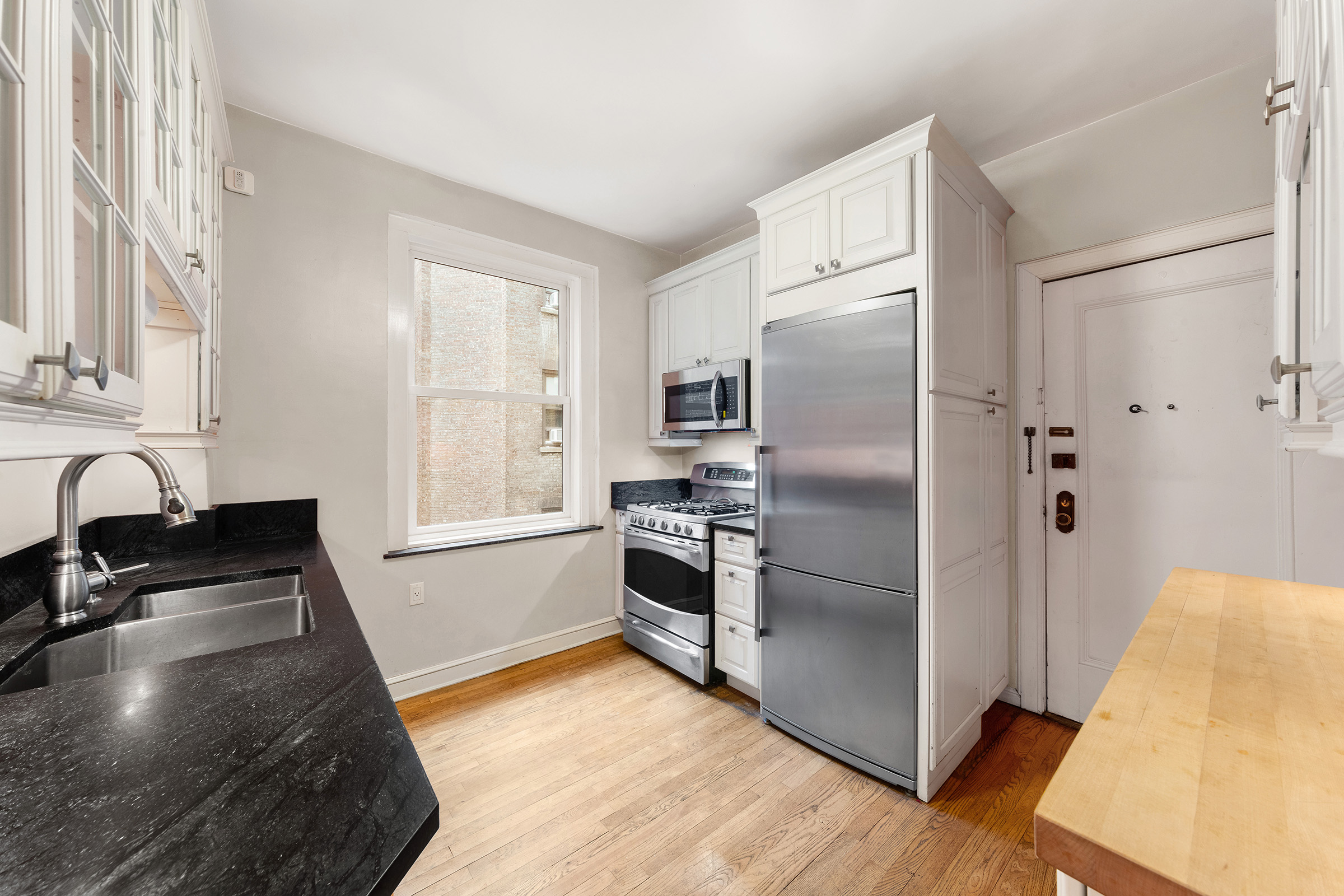 360 Riverside Drive, Unit 8A Manhattan, NY 10025 - Photo 10 of 20 a kitchen with granite countertop a refrigerator and a sink