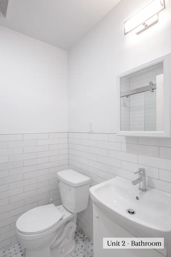 a white toilet sitting next to a bathroom sink
