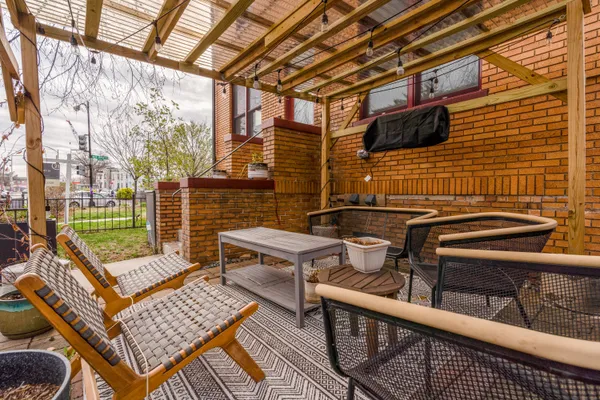 a view of a chairs and table in the balcony