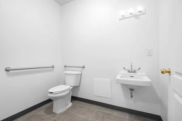a white toilet sitting next to a white sink