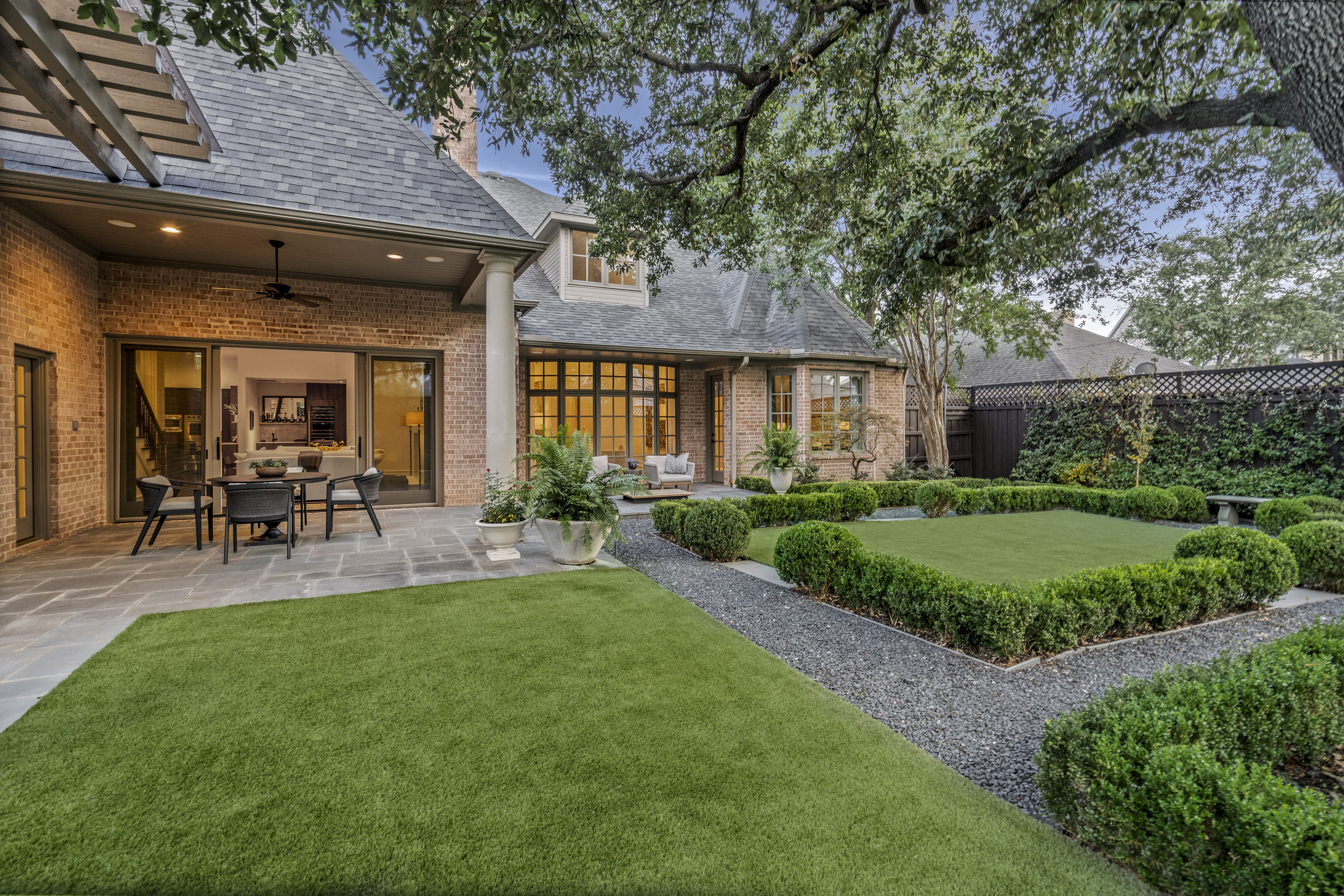 6607 Meadow Road Dallas, TX 75230 - Photo 28 of 32 a view of a patio with table and chairs potted plants and large tree
