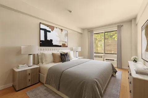 a bedroom with a bed and a night stand