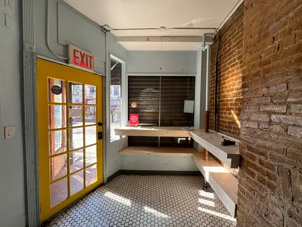 a view of an outdoor space kitchen and a window