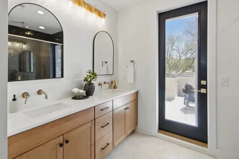 a bathroom with a double vanity sink and mirror