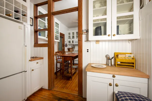 a view of a kitchen with a stove and a wooden floor