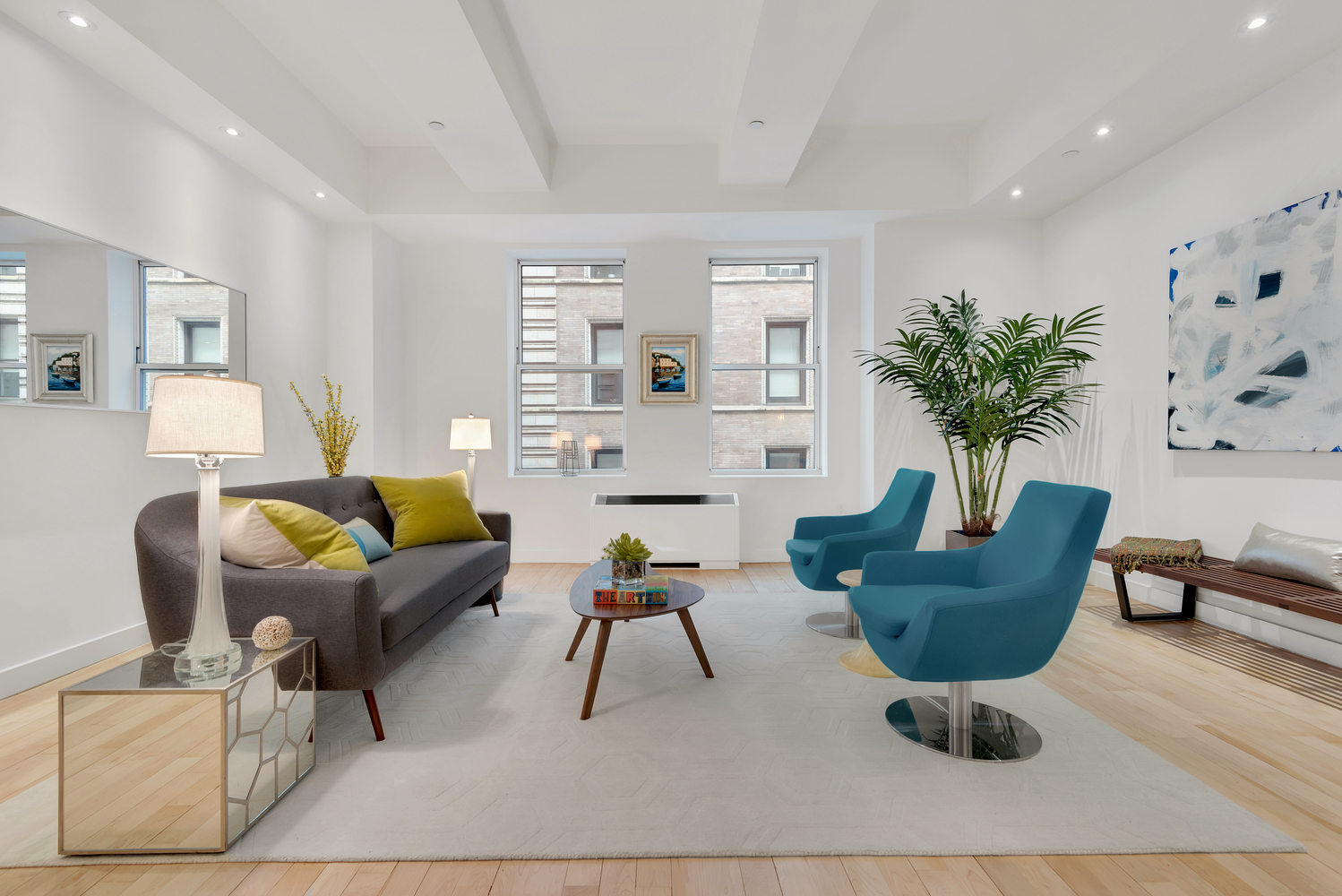 15 Broad Street, Unit 1230 Manhattan, NY 10005 - Photo 2 of 23 a living room with furniture and a potted plant