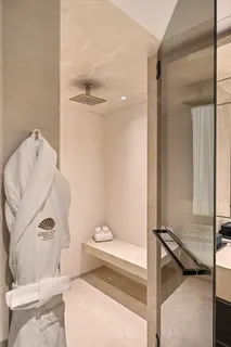 a bathroom with a toilet and a shower