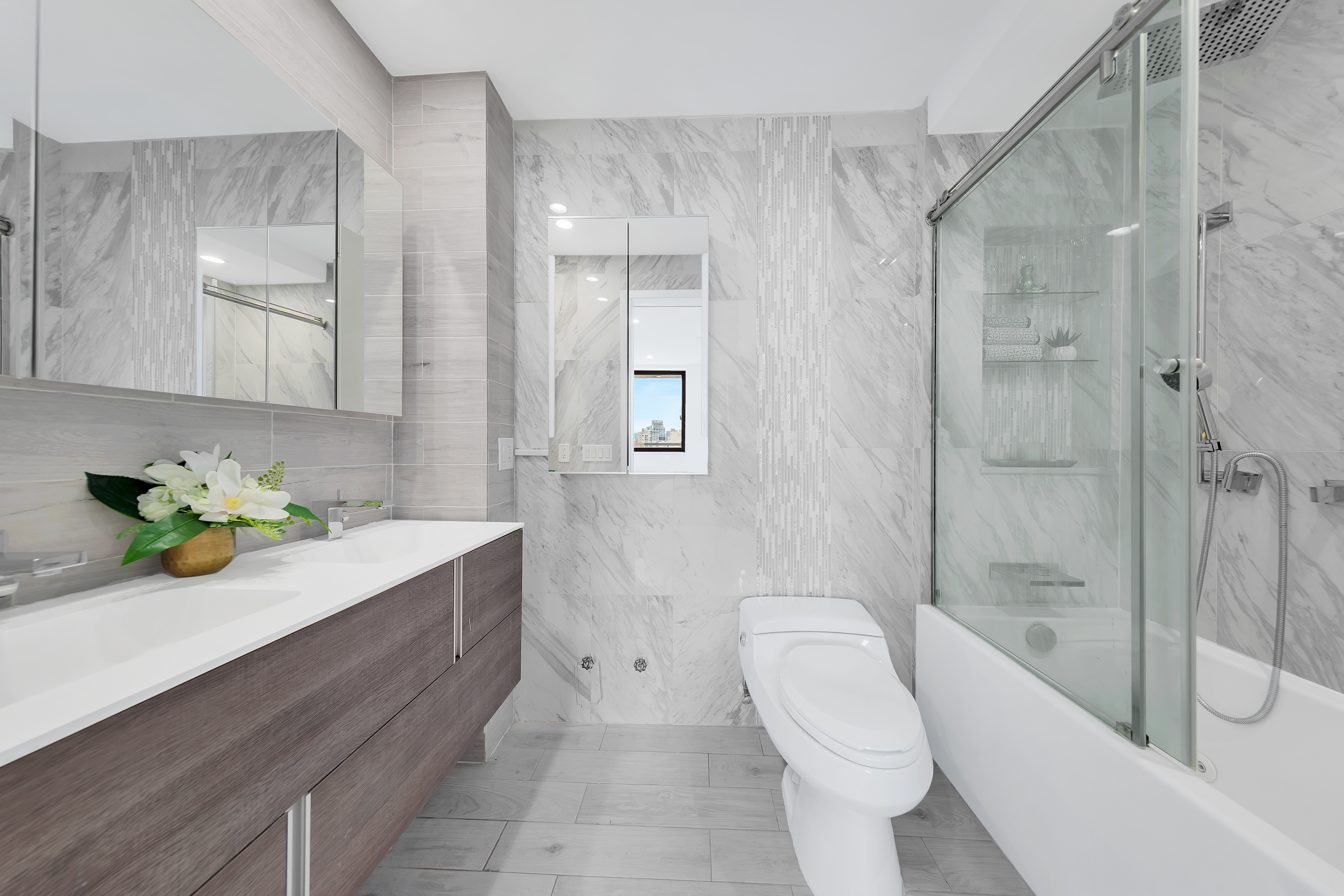 136 East Broadway, Unit PHA Manhattan, NY 10002 - Photo 7 of 12 a bathroom with a sink a toilet and shower