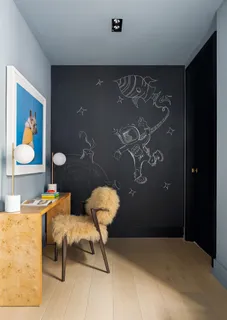 a bedroom with a table and chairs