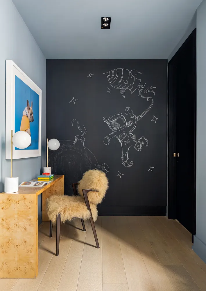 a bedroom with a table and chairs