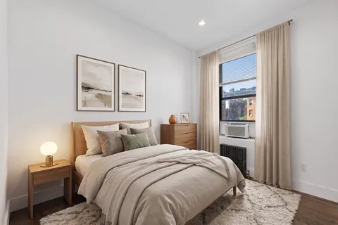 a bedroom with a bed and a window