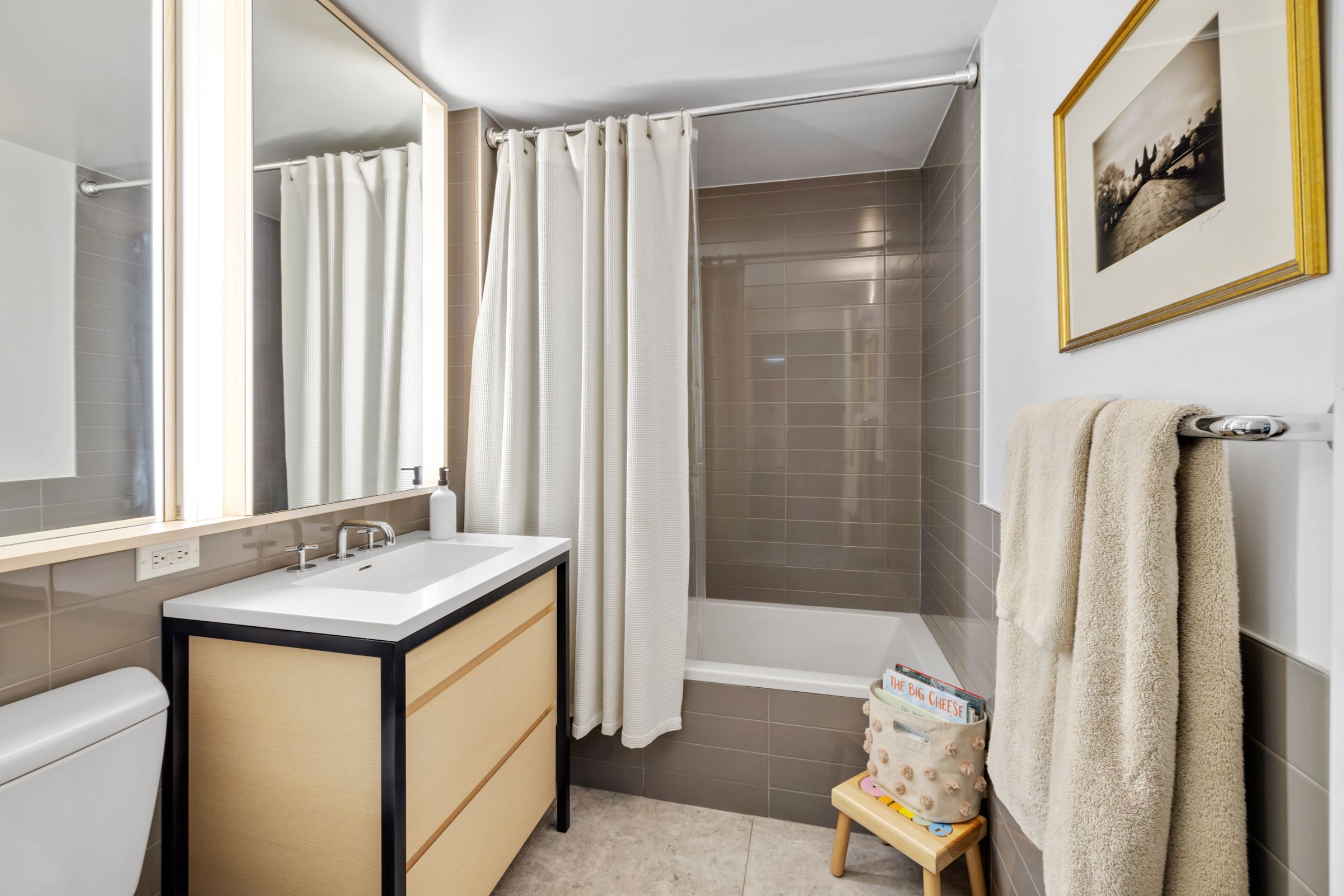 385 1st Avenue, Unit 4B Manhattan, NY 10010 - Photo 10 of 18 a bathroom with a granite countertop sink and a mirror