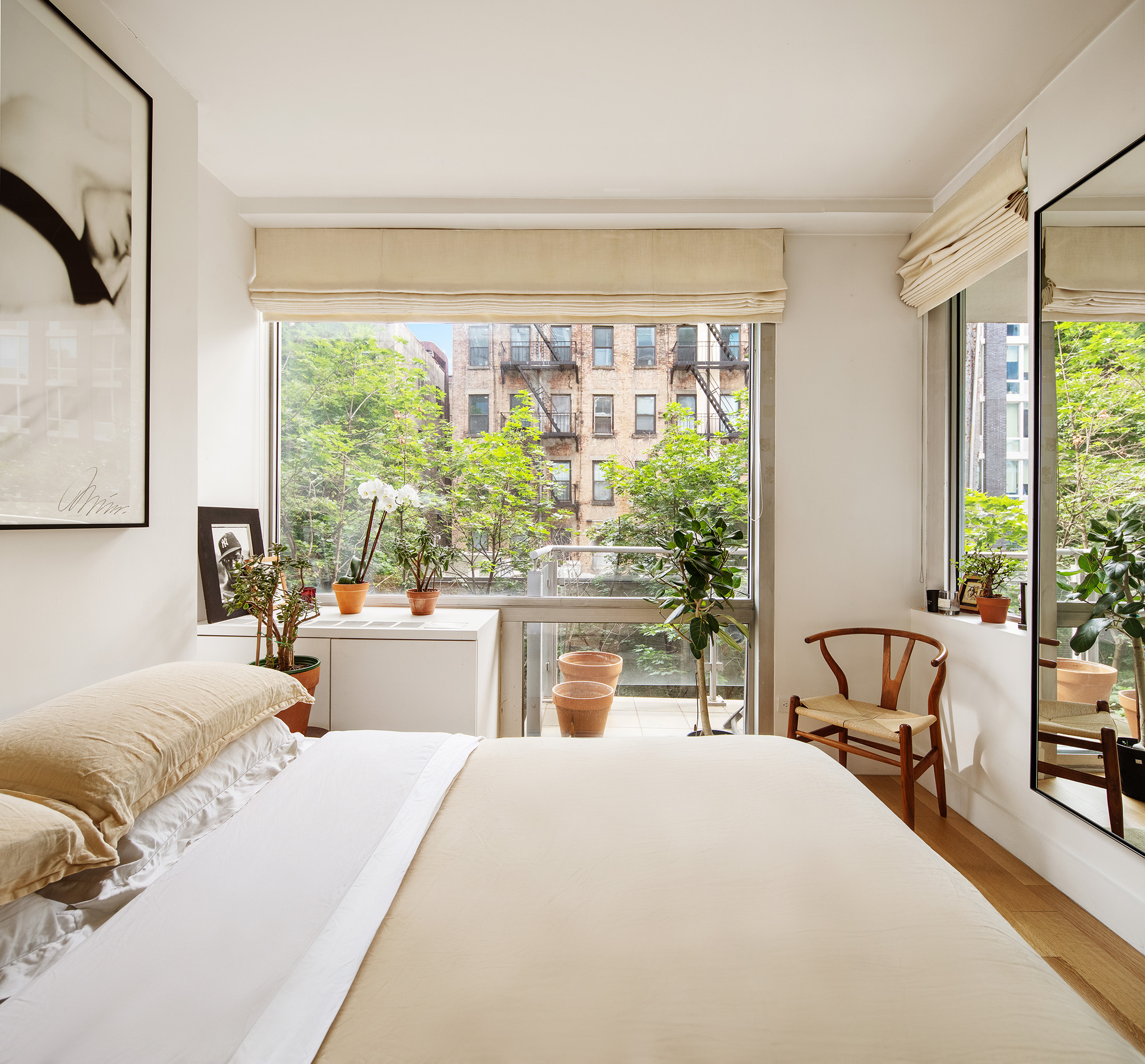 425 East 13th Street, Unit 3F Manhattan, NY 10009 - Photo 7 of 16 a bedroom with a bed and a large window