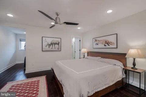 a bedroom with a large bed and a chandelier