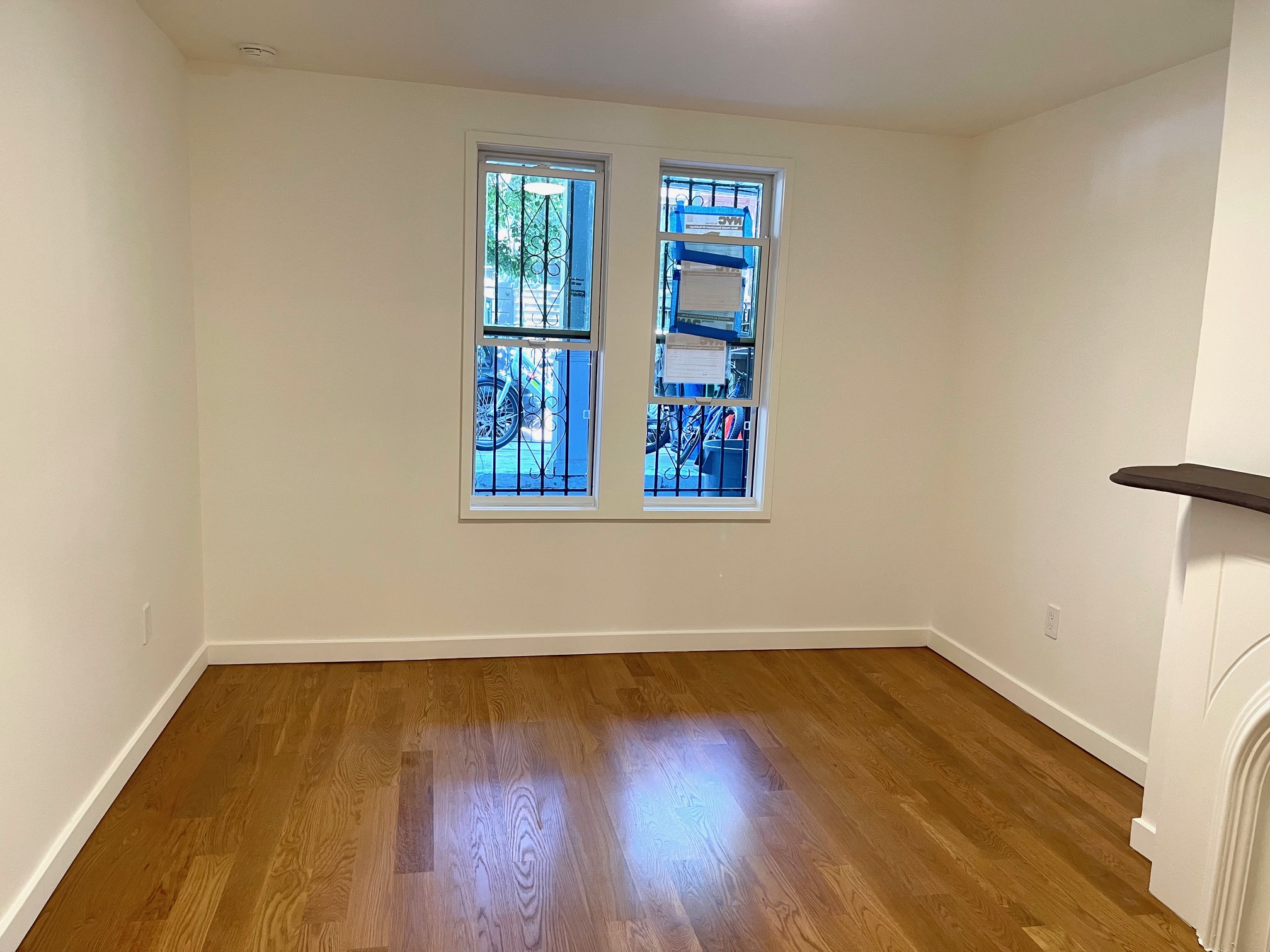 978 Bergen Street, Unit GARDEN Brooklyn, NY 11216 - Photo 6 of 15 a view of a room with wooden floor and small window