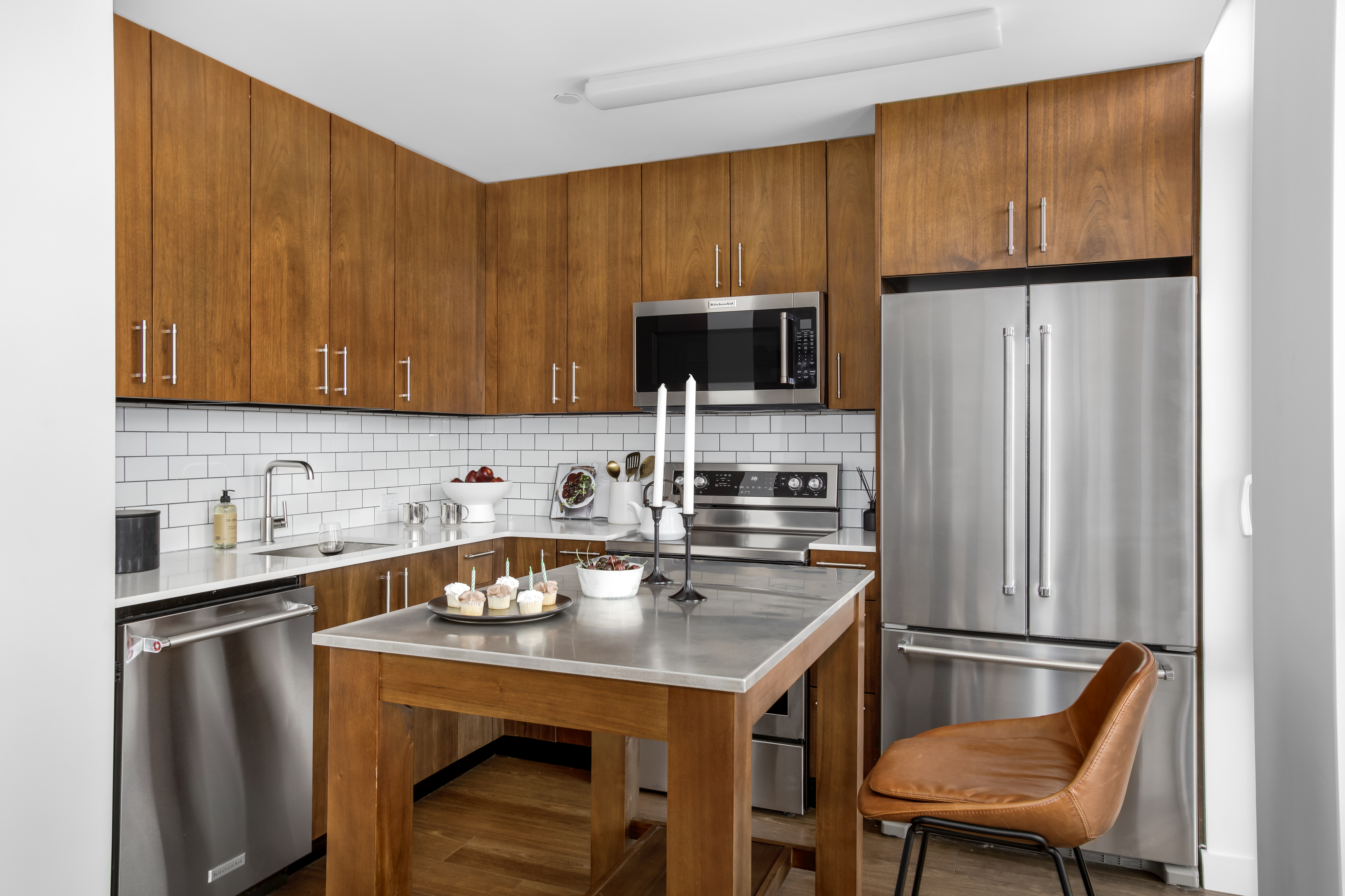 120 Nassau Street, Unit 14G Brooklyn, NY 11201 - Photo 2 of 11 a kitchen with stainless steel appliances a refrigerator a sink a stove a table and chairs