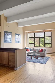 a living room with furniture and large windows