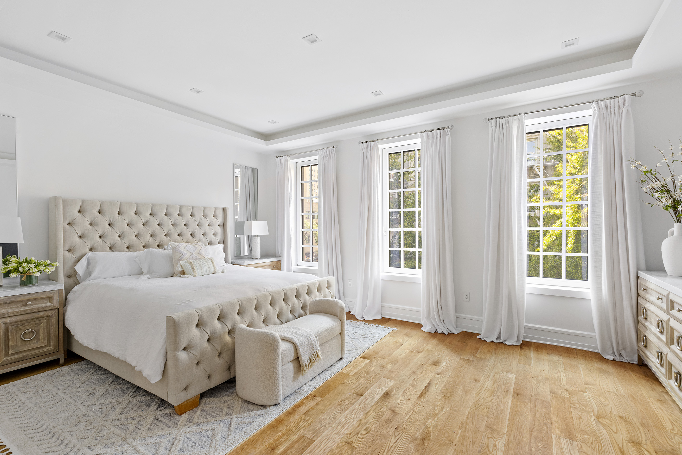 25 East 94th Street Manhattan, NY 10128 - Photo 11 of 33 a bedroom with a large bed and a couch