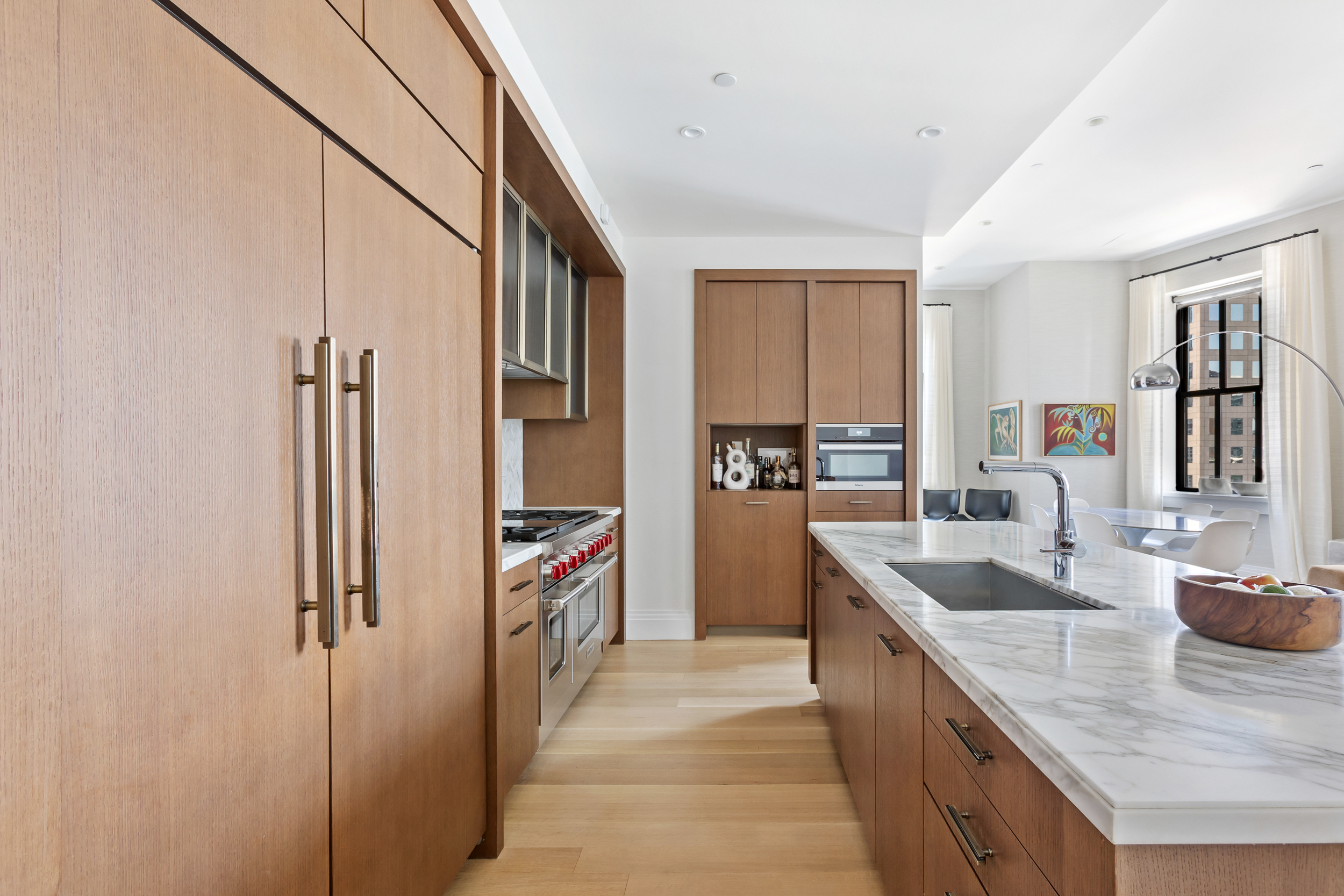 100 Barclay Street, Unit 17A Manhattan, NY 10007 - Photo 4 of 24 a kitchen with stainless steel appliances granite countertop a refrigerator and a sink