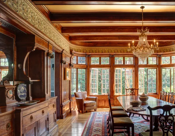 a living room with furniture a flat screen tv and floor to ceiling window