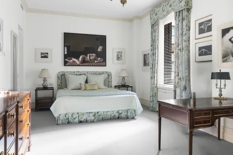 a bedroom with a bed and a table