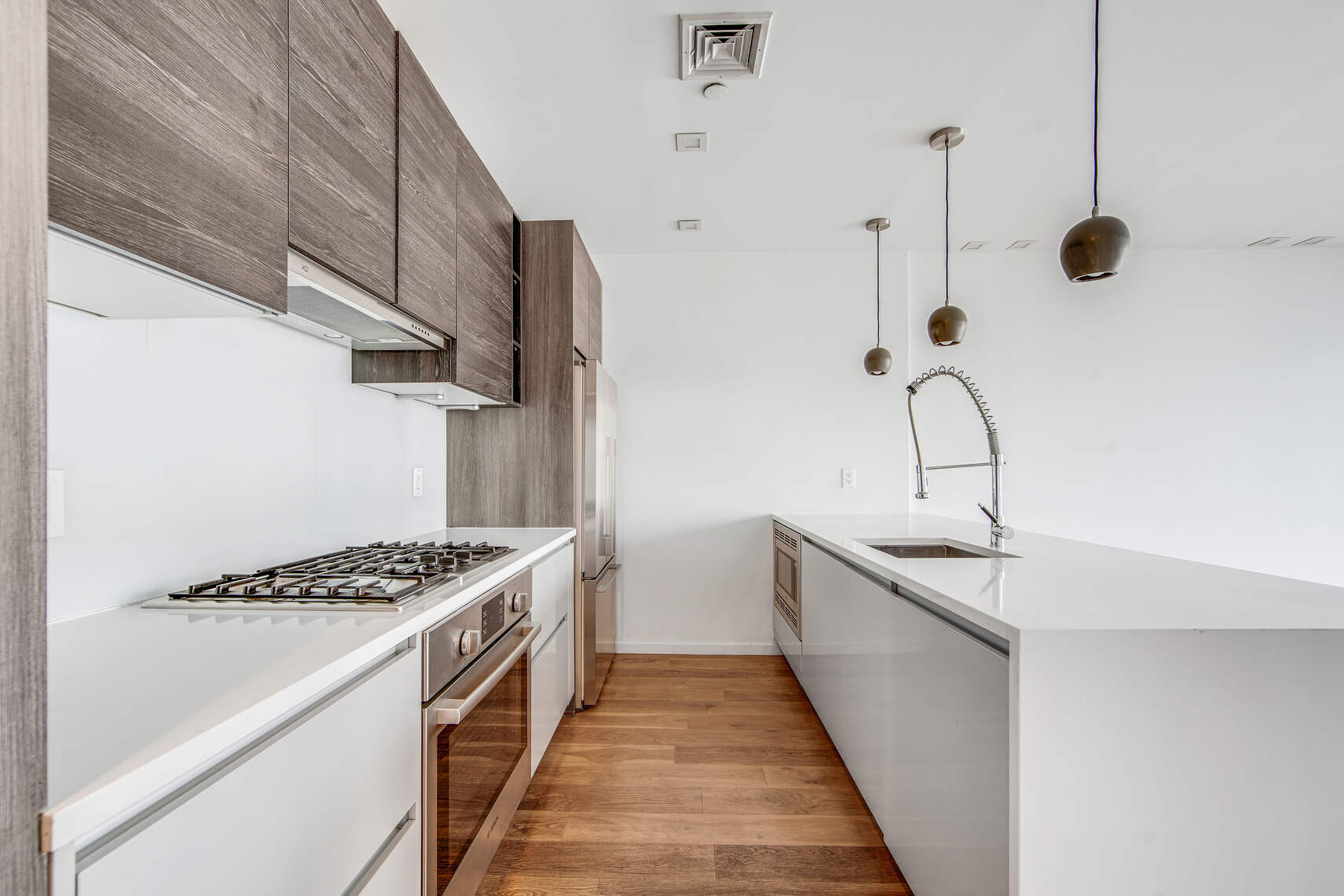 511 Lafayette Avenue, Unit 3B Brooklyn, NY 11205 - Photo 5 of 14 a kitchen with stainless steel appliances a sink a stove and a wooden floor