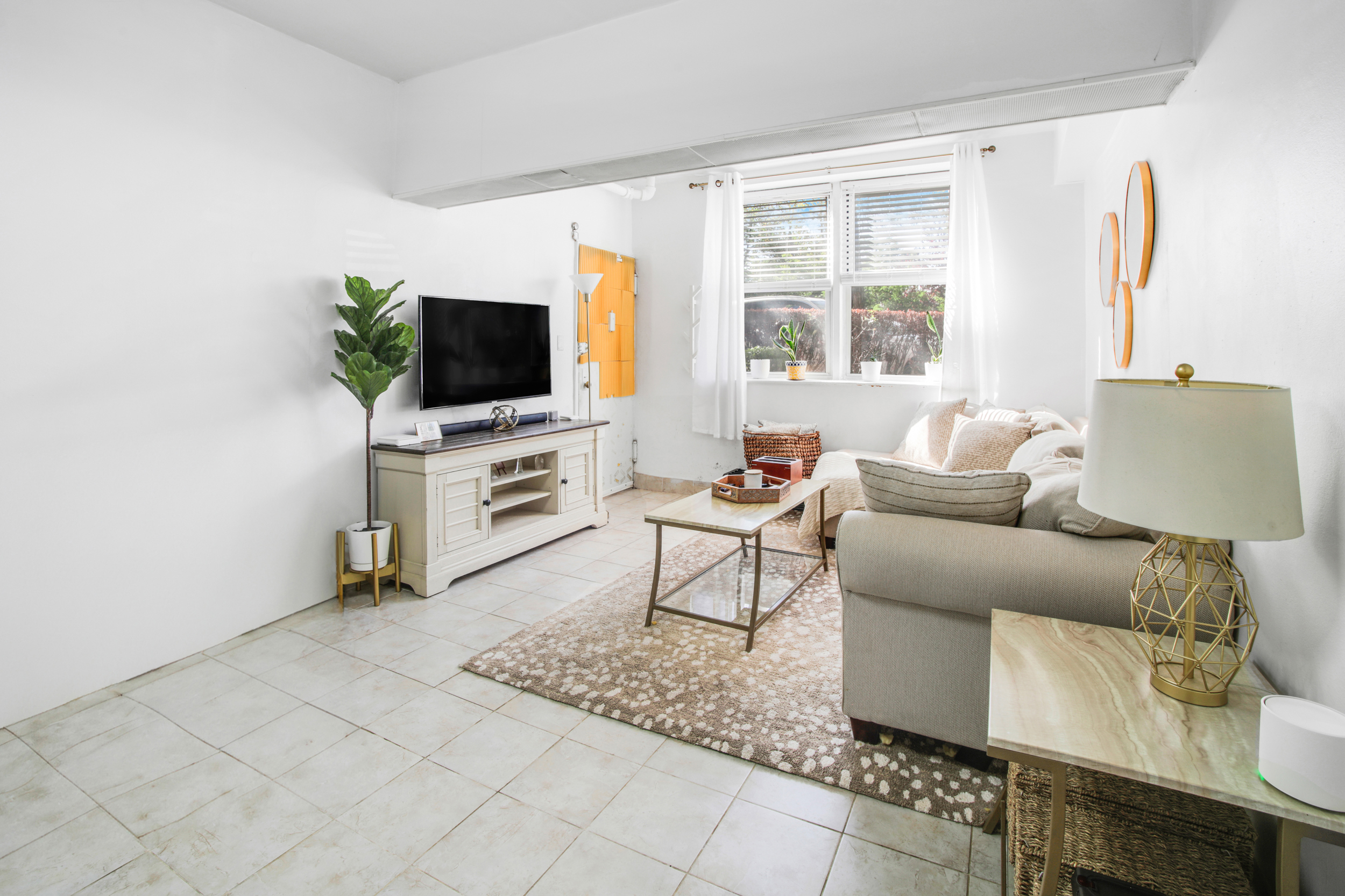 9801 Shore Road, Unit BB Brooklyn, NY 11209 - Photo 2 of 13 a living room with furniture and a flat screen tv